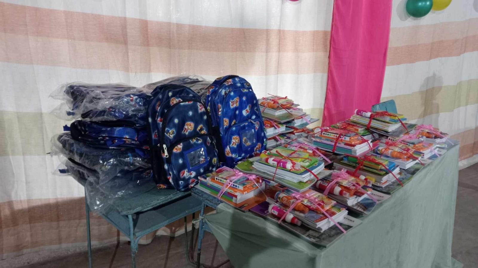 Children receiving school supplies and learning materials
